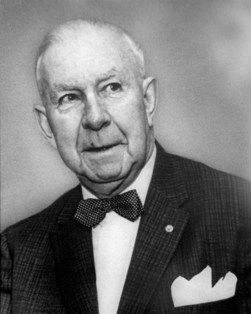 an old black and white photograph of Eddie Mulligan in a blazer and bow tie