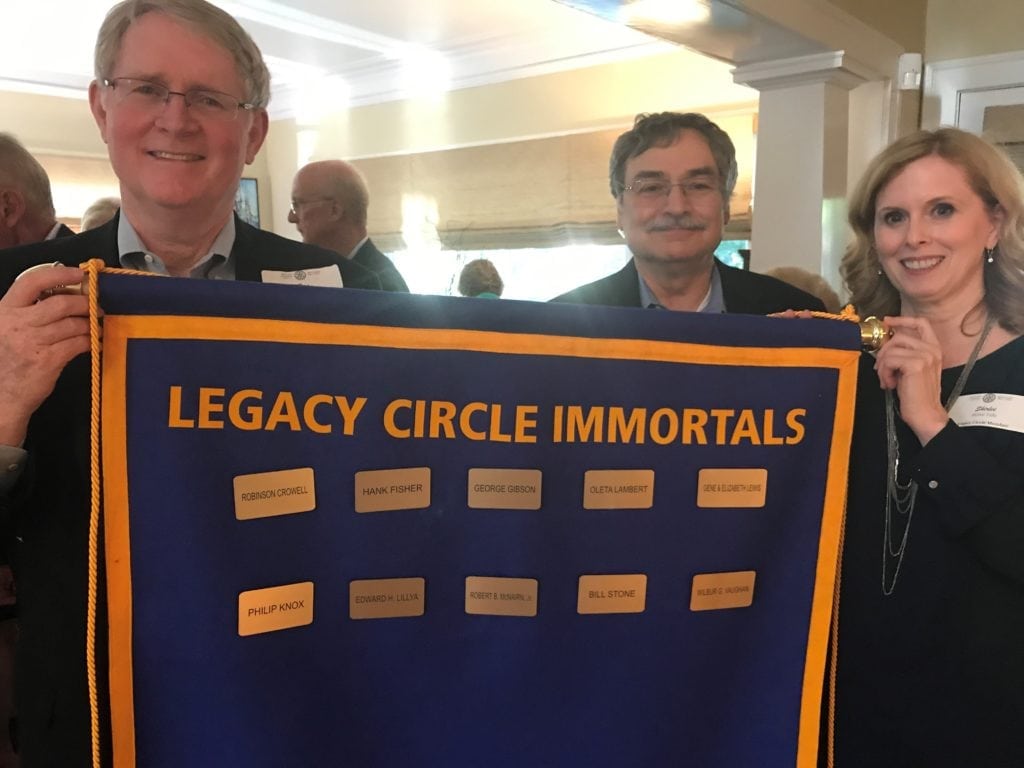 an image of people holding a sign that says Legacy Circle Immortals