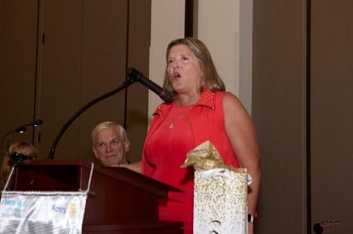 an image of a women speaking at a banquet