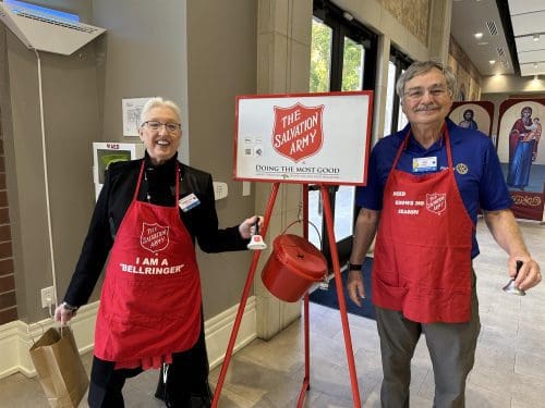 two people at a salvation army donation bin