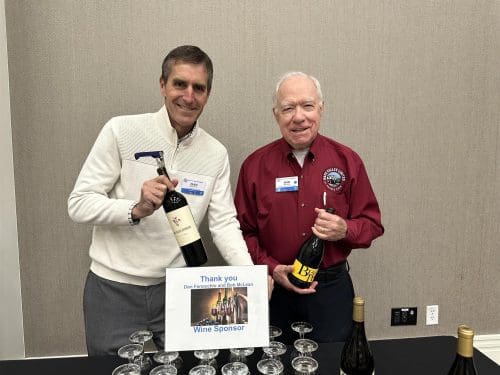 Two men holding bottles 