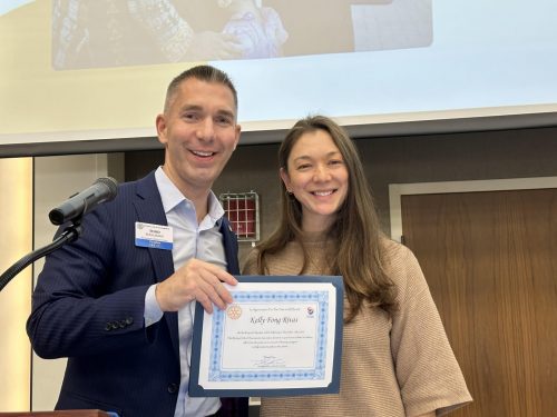 Man holding certificate with Kelly Fong Rivas