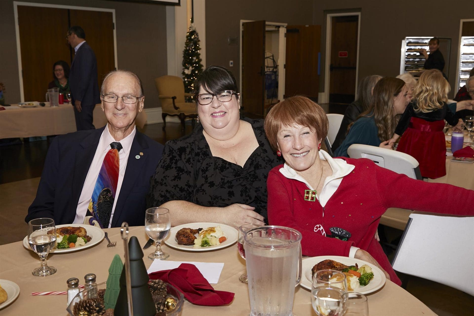 Group of three posing for camera at table