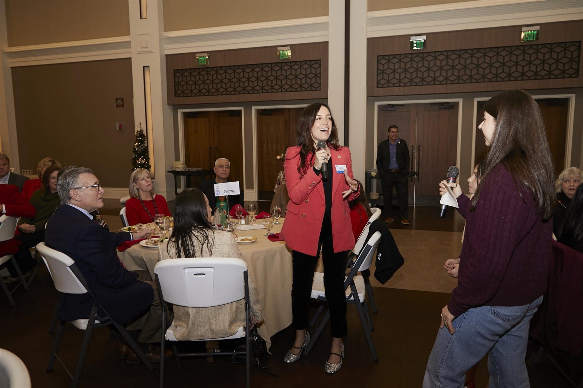 Two woman speaking into microphones