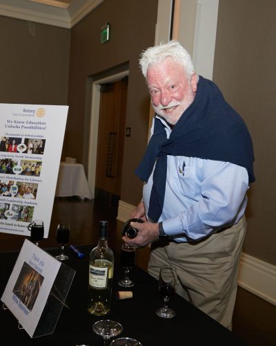 Smiling man pouring wine