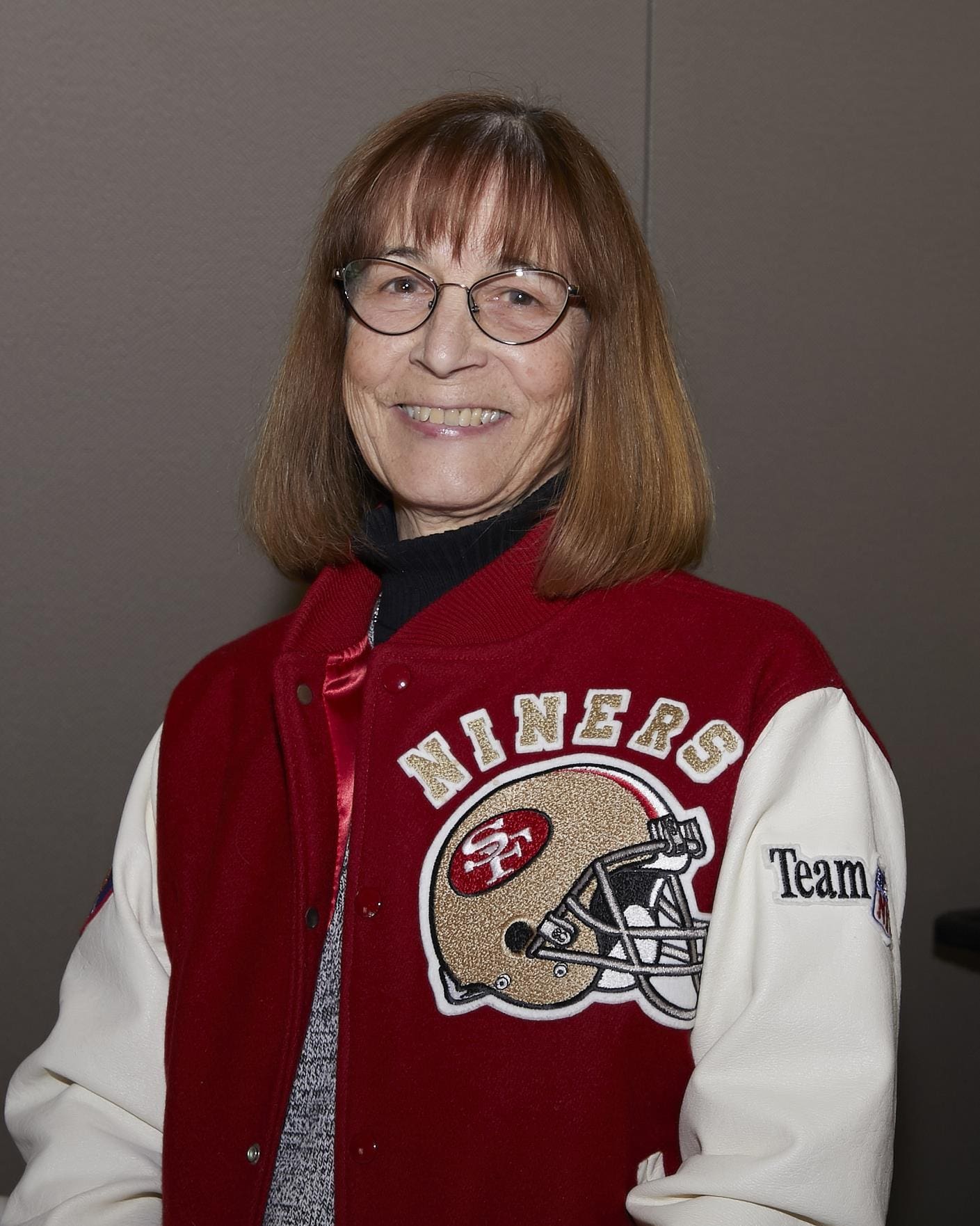 person wearing a niners jersey smiling