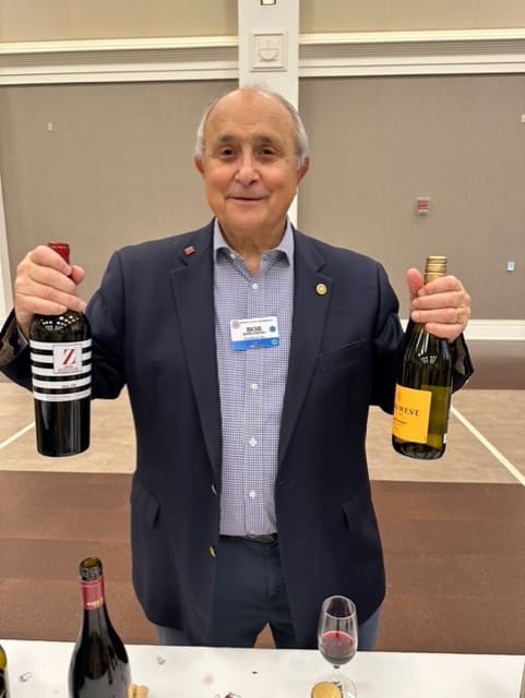 person smiling and holding up bottles