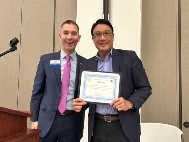 2 people smiling and 1 holding an appreciation award