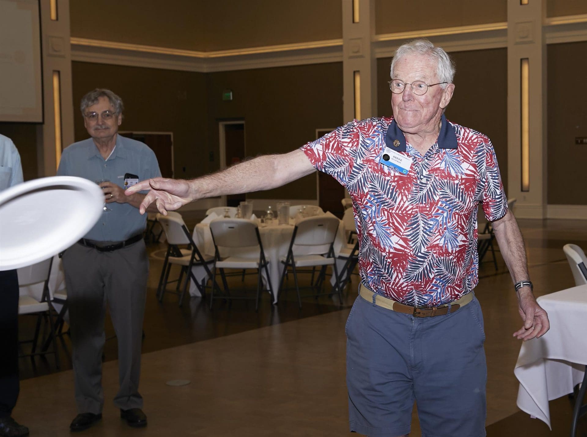 person throwing a paper plate at something off camera
