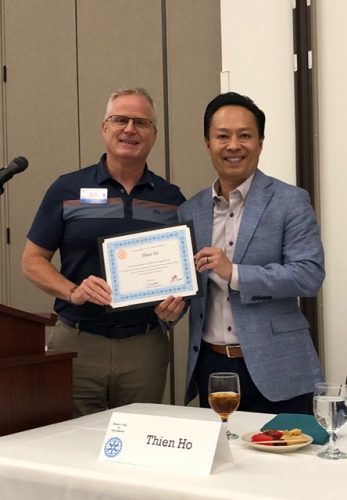 two people holding a certificate