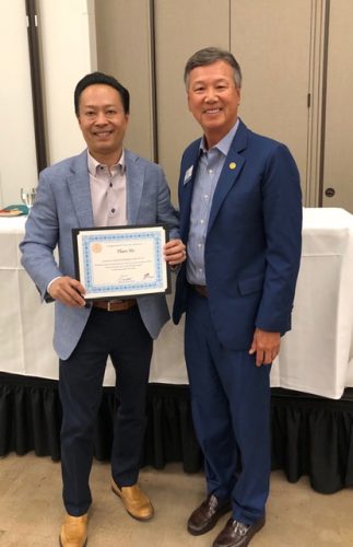 two people holding a certificate