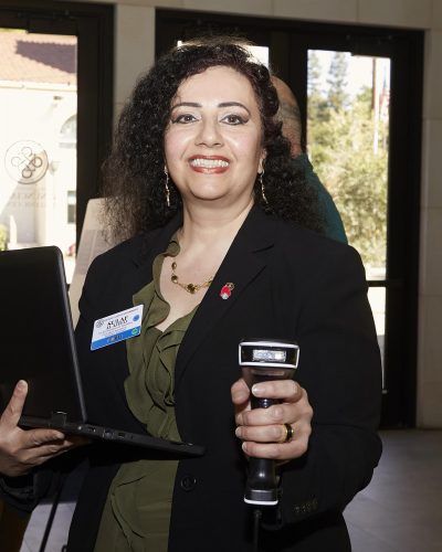 woman pointing a scanner at the camera