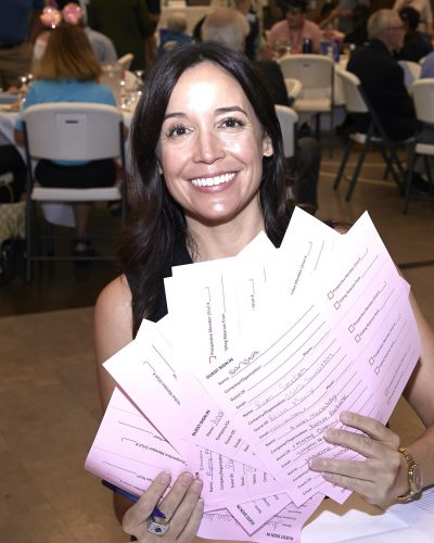 woman holding up papers