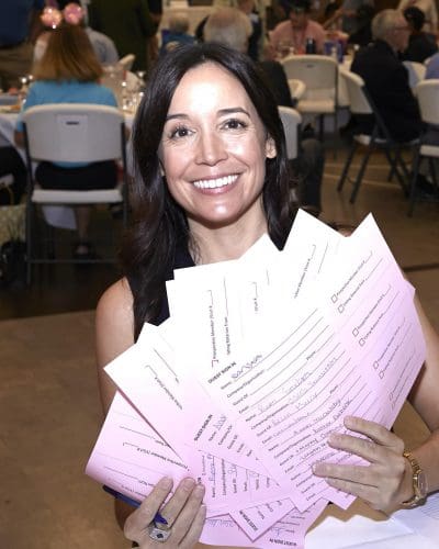 woman holding up papers