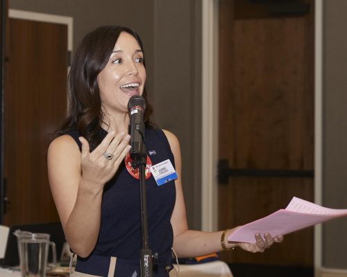 woman speaking into microphone