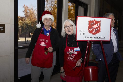 2 people holding a salvation army sign