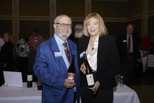 photo of 2 people holding bottles