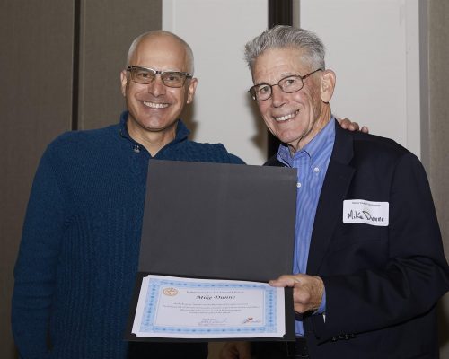 two people holding a certificate