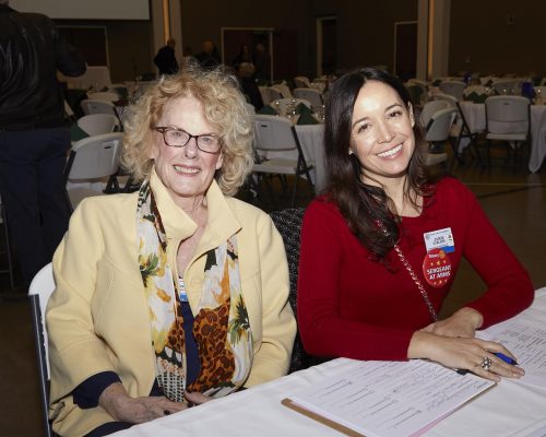 two people sitting at desk 
