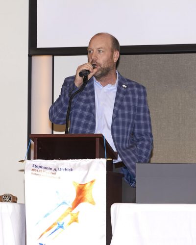 bobby speaking into microphone on the stage