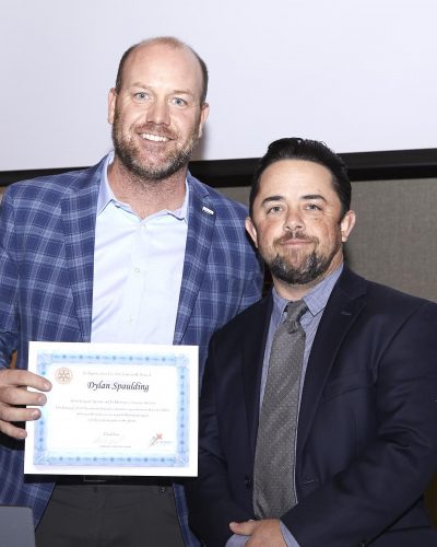 bobby holding certificate next to someone