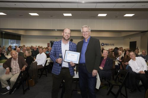bobby holding a certificate