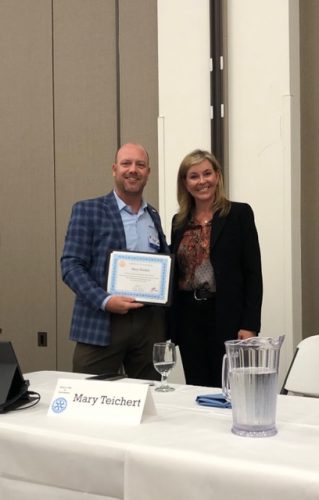 bobby holding a certificate with someone