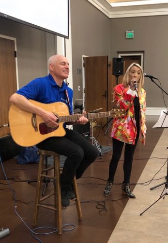 people playing instruments into microphone