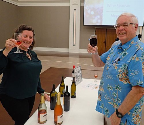 two people holding up bottles