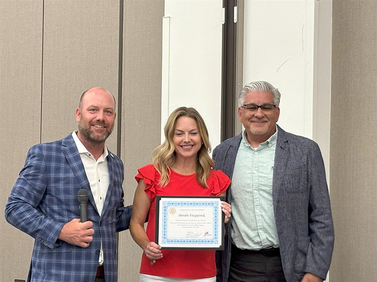 Fitzpatrick holding a certificate and taking photo with Bobby and Manoucheri