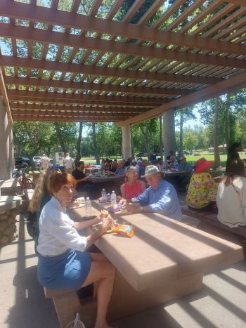 People sitting on the bench having snacks