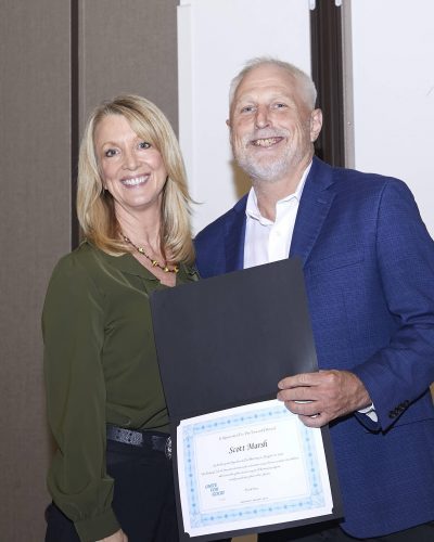 two people posing for a photo with a certificate on hand