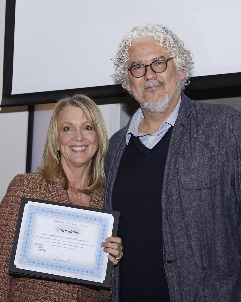 a man and a woman standing next to each other while the woman is holding a certificate/award