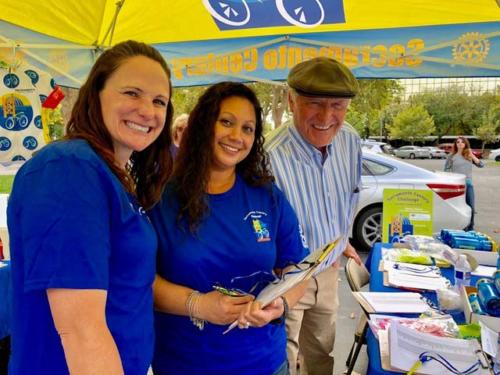A man and two women volunteer at the Sacramento Century Bike race