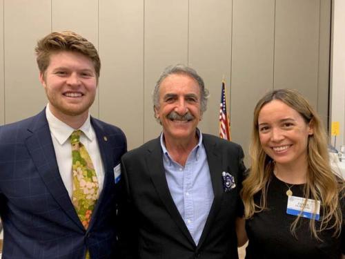 An elder and two young members of Rotary Club smile at the camera.