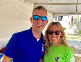 Two people pose for the camera wearing sunglasses and Sacramento Century Bike Race Tshirts