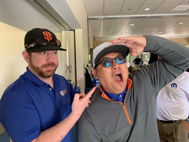 Two men strike goofy poses