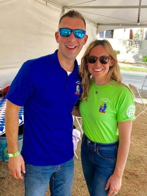 Two people pose for the camera wearing sunglasses and Sacramento Century Bike Race Tshirts