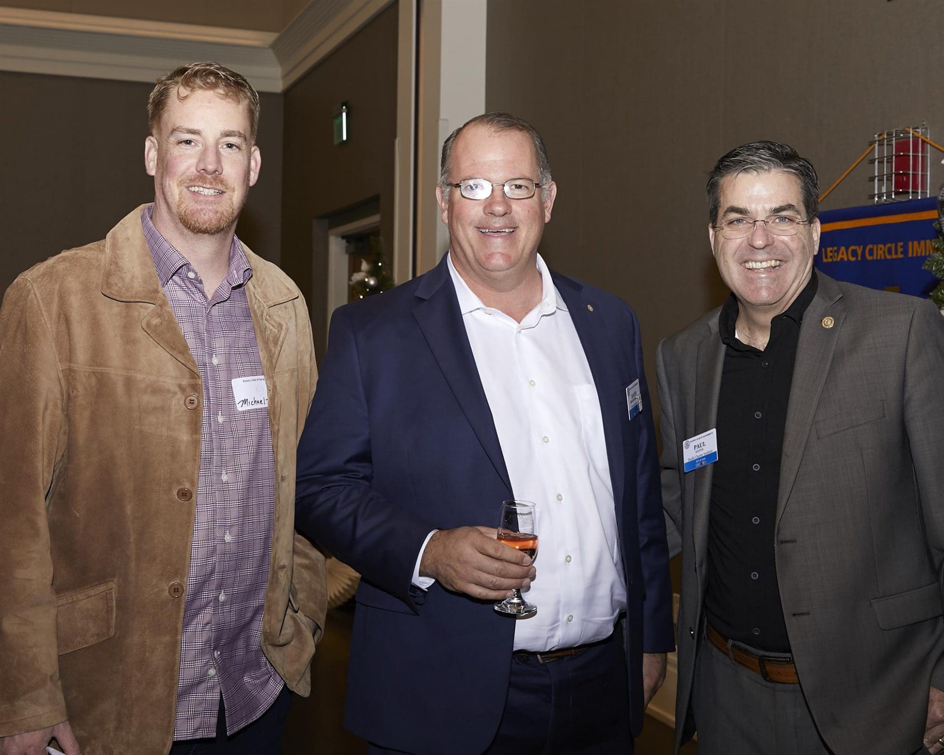 Three men posing for camera