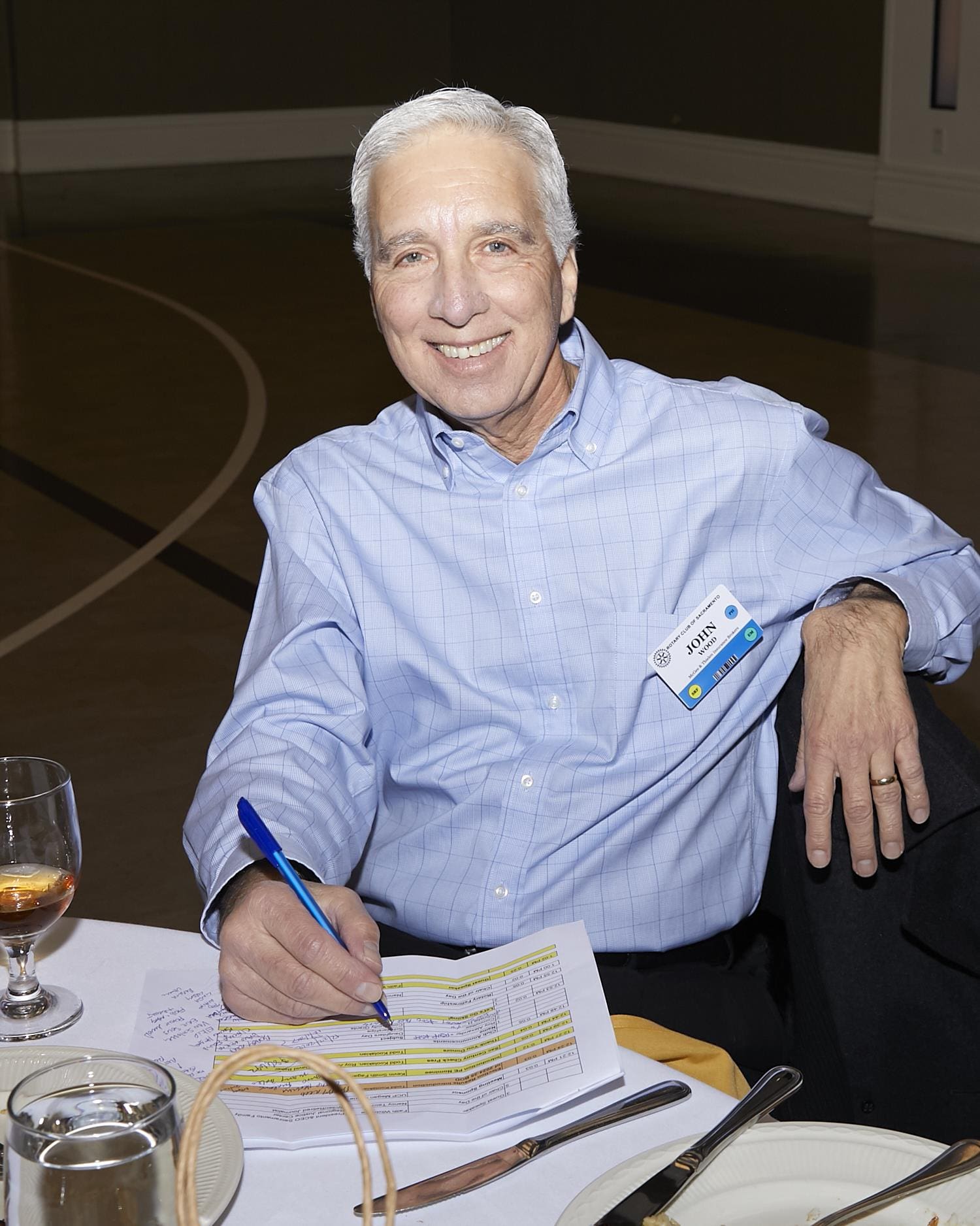 John Wood sitting and smiling for the camera