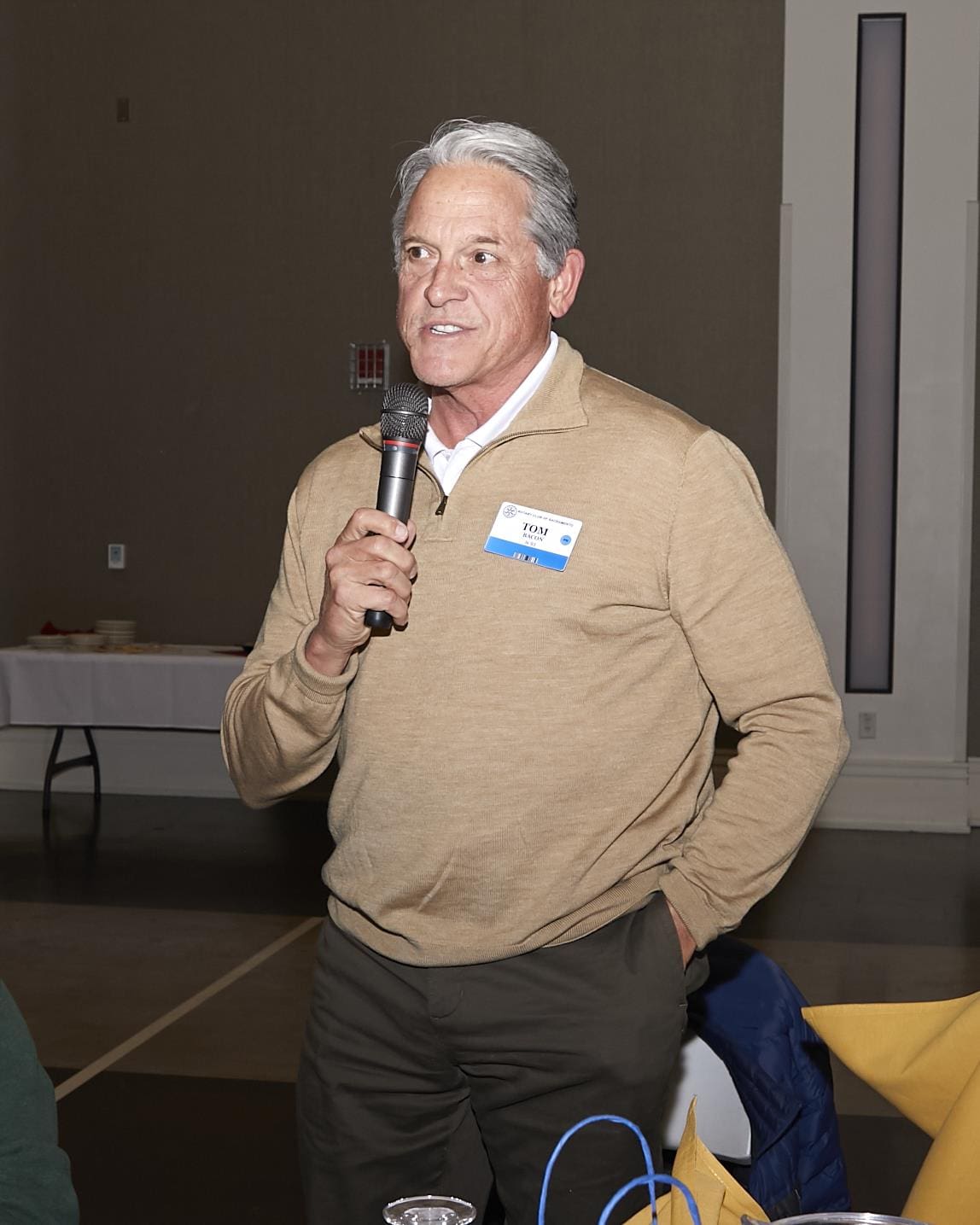 Man holding and speaking into microphone