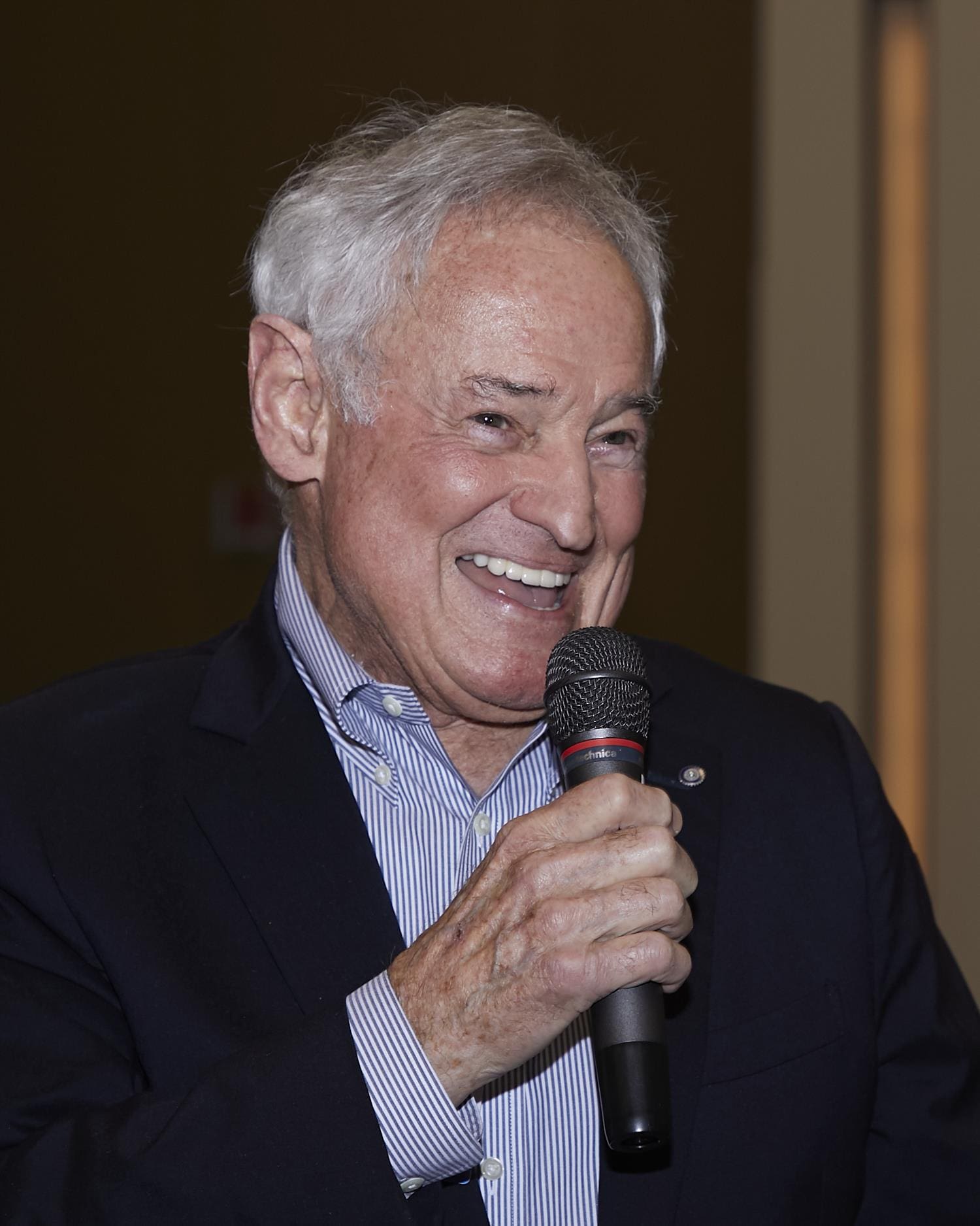 Man holding and speaking into microphone