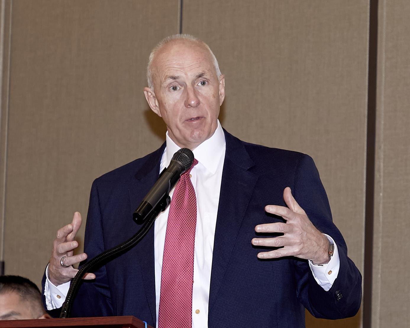 a speaker using his hands to express what he is saying