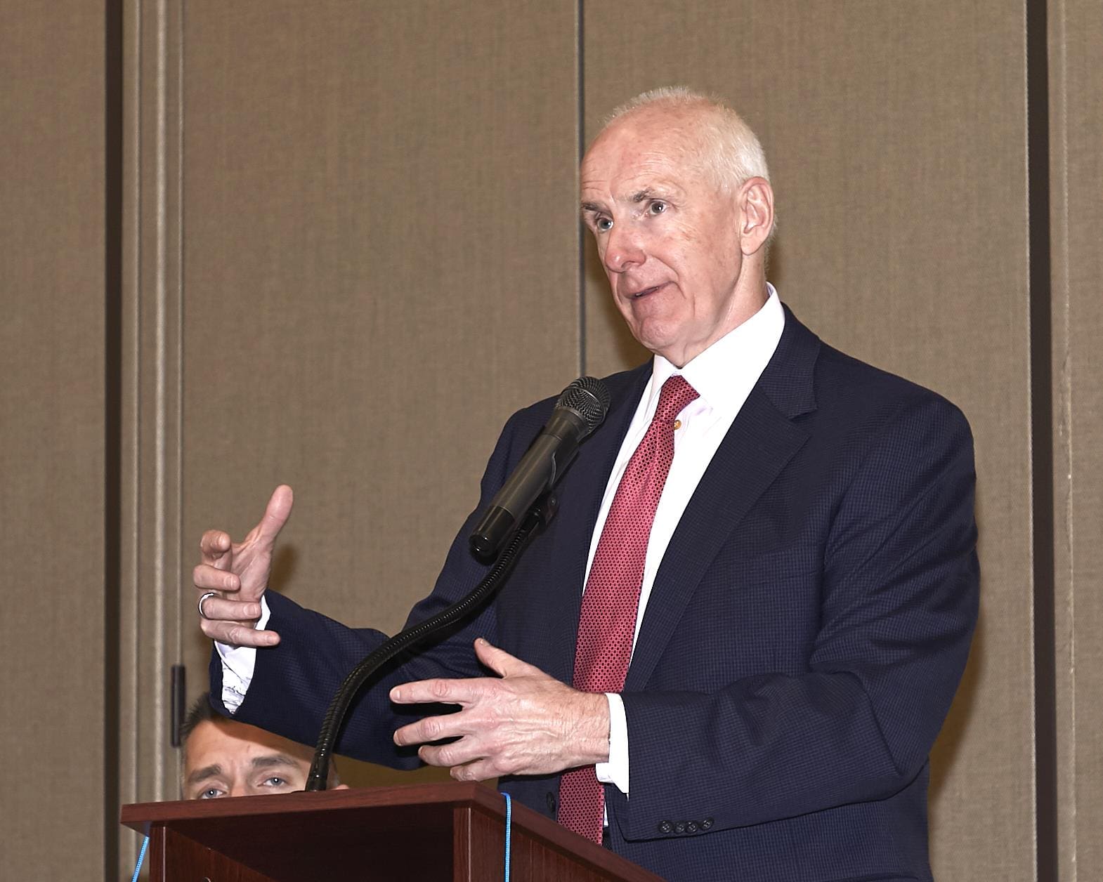 a speaker using his hands to express what he is saying