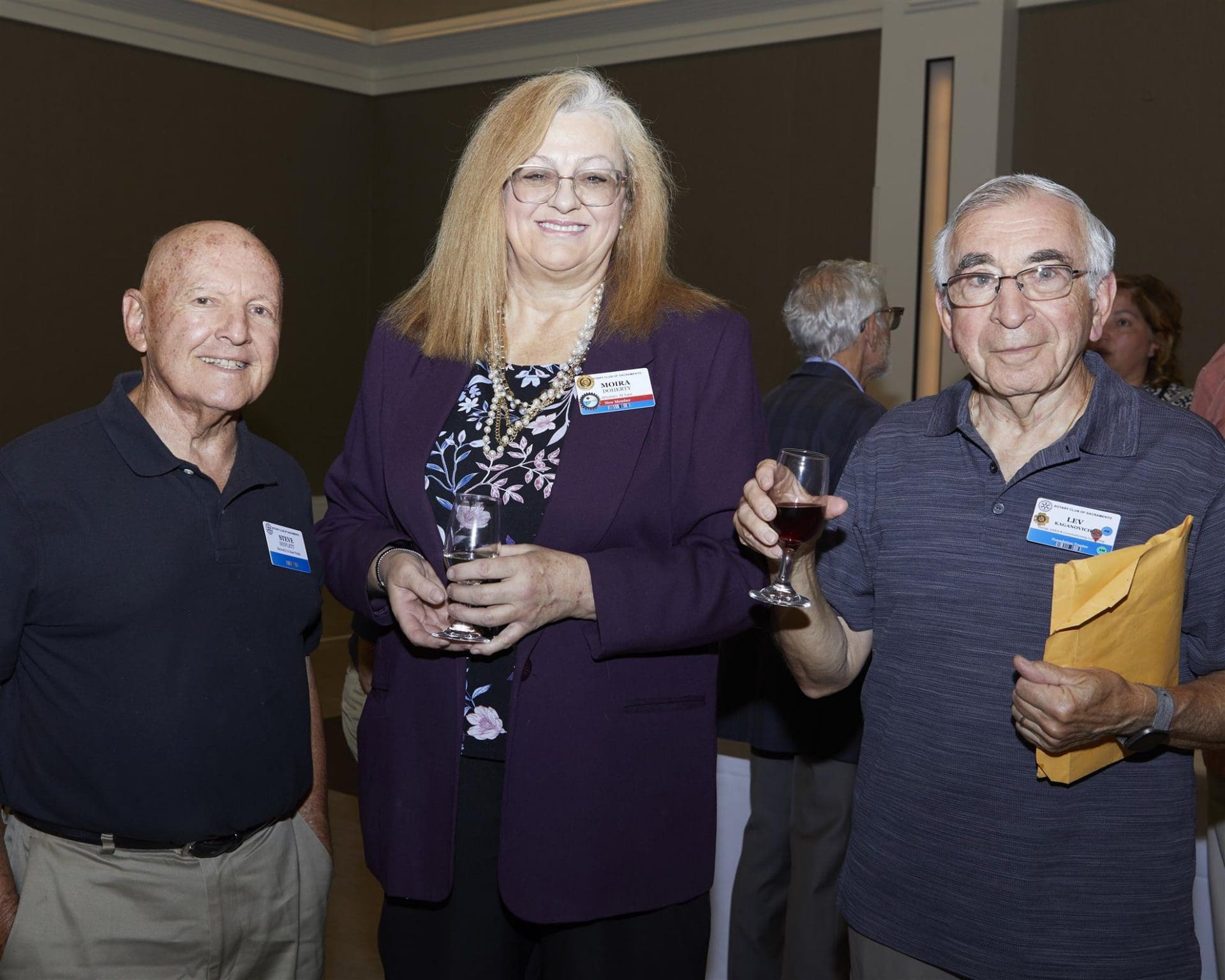 3 people smiling and holding their drinks