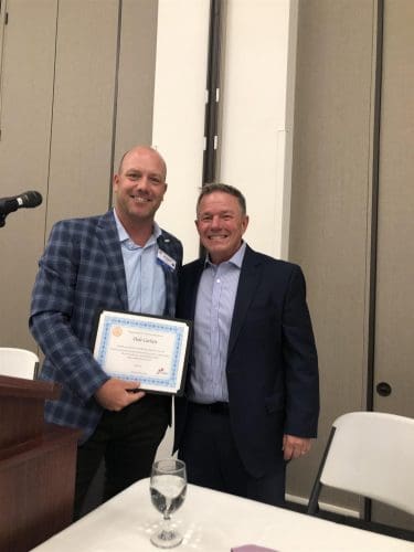 two people holding a certificate