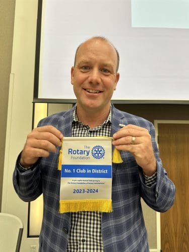 president bobby reed holding up a certificate