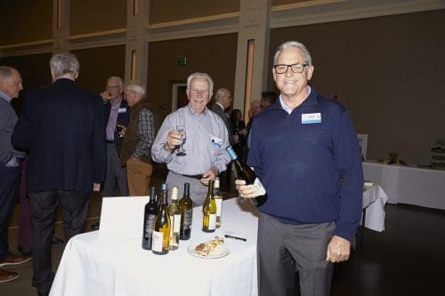 people holding bottles