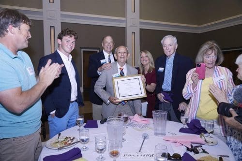 Rotary members at a meeting gathered around a round table