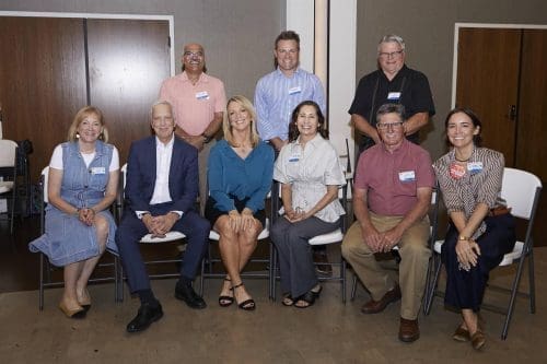 A bunch of rotary members sitting in chairs